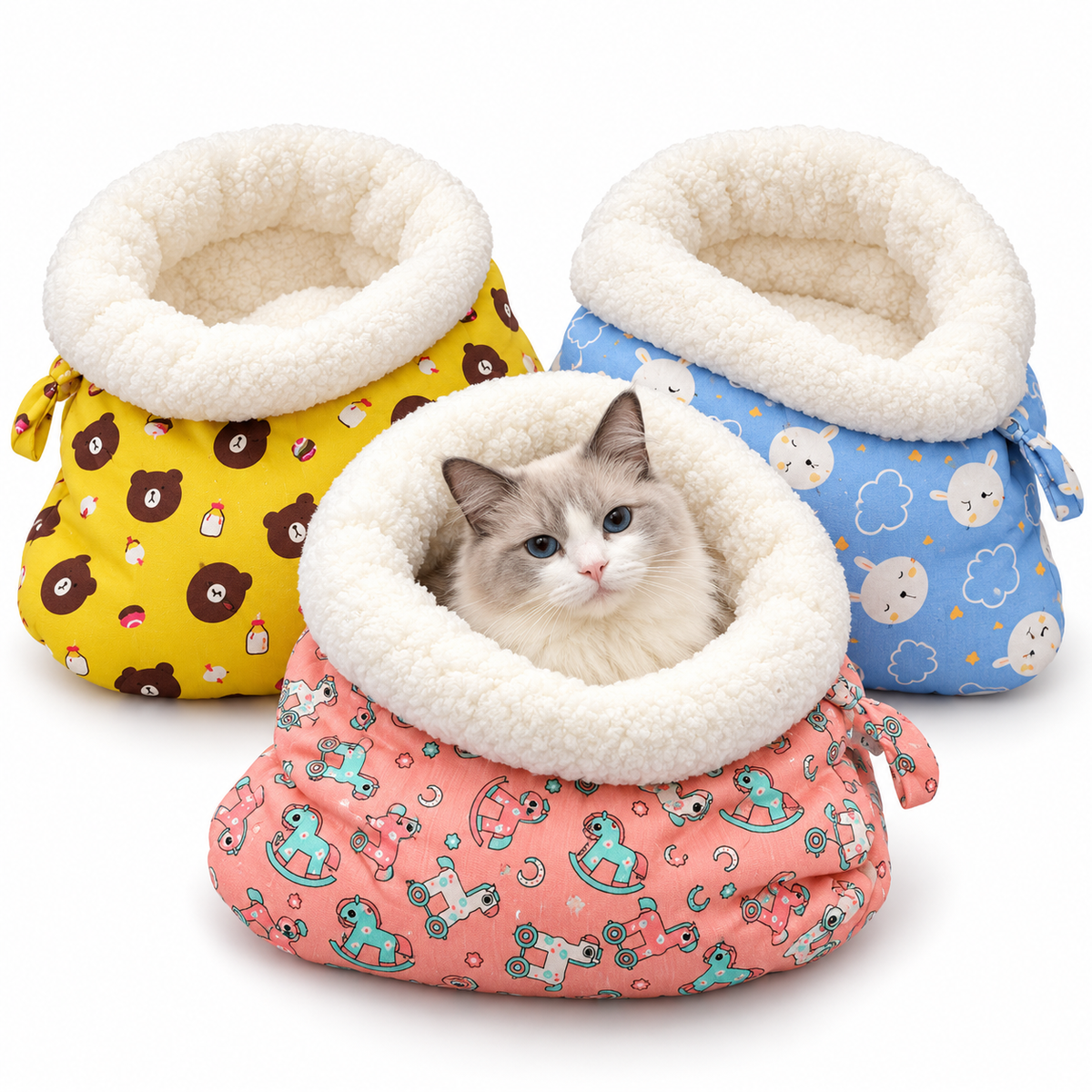 Plush cat sleeping bags in yellow, blue and pink prints with a cat resting inside